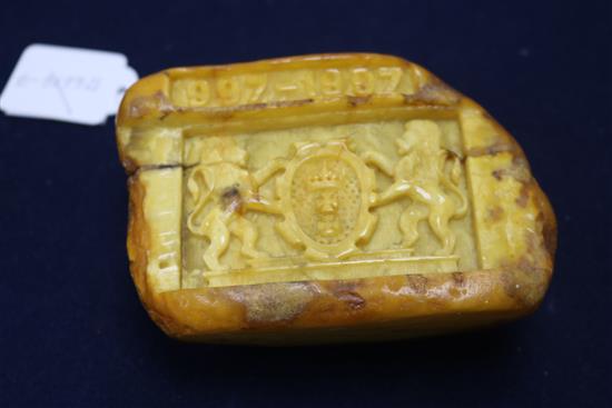 A piece of raw amber carved with the crest of the Polish City of Gdansk with the date 997-1997.